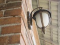 Brown Decorative Electric Lamp Mounted On A Brick Wall