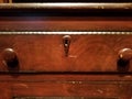 Brown desk and drawer with knobs and keyhole Royalty Free Stock Photo