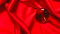 Brown diamond on luxury red satin fabric. background. elegant wallpaper desing Royalty Free Stock Photo