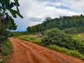 Brown dirt road street hill dwon mountain bike farm field north chiang mai outside nature forest village doi Thailand Royalty Free Stock Photo