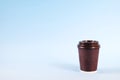 Colorful simplistic minimal composition with heat proof paper coffee cup. Take out tea mug with plastic cap. Coffee shop concept. Royalty Free Stock Photo