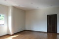 Brown door close with white wall in new house. wooden laminate floor in living room Royalty Free Stock Photo