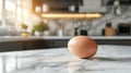 Brown Easter Egg on White Marble Kitchen Counter with Blurry Modern Kitchen Background Royalty Free Stock Photo