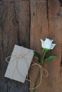 Brown eco friendly gift box decorated with soft pink and white rose on white wooden table, sweet lovely present valentine concept Royalty Free Stock Photo