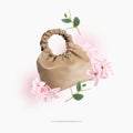 A brown eco-leather bag, leaves, flowers float on a light gray background. A creative composition of a levitating vegan leather Royalty Free Stock Photo