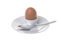 Brown egg in a cap and spoon on a white background Royalty Free Stock Photo