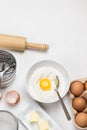 Brown eggs in carton container. Butter and whisk on plate. Egg yolk with flour in bowl Royalty Free Stock Photo