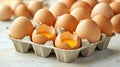 Brown eggs in a carton with some broken, yolks visible. Royalty Free Stock Photo