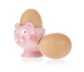 Brown eggs and easter pig cup isolated on white Royalty Free Stock Photo