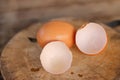 Brown eggs with egg shells on a wooden chopping board On the bamboo battens