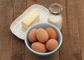 Brown eggs, milk, and butter in country setting Royalty Free Stock Photo