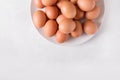 Brown eggs on a white plate on a white background. Eggs. Easter photo concept. Royalty Free Stock Photo