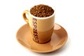 Brown elegant cup full of instant coffee granules, saucer under it. View from above, so it makes perfect round shape.