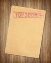 Brown envelope with top secret stamp isolated on on wood background Royalty Free Stock Photo