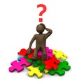 Brown figurine sitting on pieces of puzzle, asking