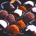 Brown filled dark chocolate and cocoa powder truffles, praline, dessert, confectionery, cooking, food - AI generated, generative
