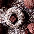 Brown filled dark chocolate and cocoa powder truffles, pralines, dessert, confectionery, food, cooking - AI generated, generative