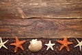 Brown fishing net, starfish and shell on wooden background Royalty Free Stock Photo