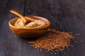 Brown flax seeds on spoon and flaxseed oil in glass jug on wooden table. Flax oil is rich in omega-3 fatty acid.