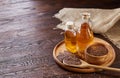 Flax seeds in bowl and flaxseed oil in glass bottle on wooden background, top view, close-up, selective focus