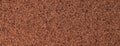 Brown fluffy background of soft, velour fabric. Texture of umber wool textile