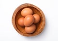 Brown fresh raw eggs in wooden bowl plate on white background Royalty Free Stock Photo