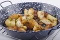 Brown fried potatoes in a pan