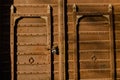 Brown gate with two round knockers and a latch, in Mandawa haveli in Rajasthan India