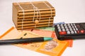 Brown gift box on malaysia notes with calculator and pen Royalty Free Stock Photo