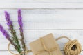 Brown gift box and rope decorated with violet liatris flowers Royalty Free Stock Photo