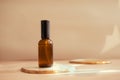 Brown glass cosmetic bottle on minimalist background