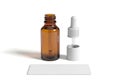 Brown glass dropper bottle with white cap and dropper isolated on white background Royalty Free Stock Photo