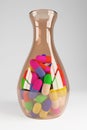 A brown glass jar filled with multicolored medicine capsules. 3D rendering