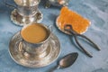 Brown Grape sugar in clear crystals, tea and tongs on grey slate close-up. Oriental sweetness to tea Royalty Free Stock Photo