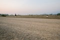 Brown gravel road In a rural area in Thailand There is a kilometer pole..In the back Royalty Free Stock Photo