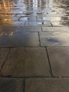 Stone pavement perspective, square floor tiling after rain. Royalty Free Stock Photo