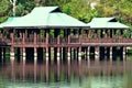 Brown and Green Gazebos on Stilts Above Water