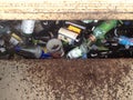 Brown green glass bottles in metal recycle bin