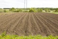 Brown ground plowed field, harrow lines. Arable background. A freshly ploughed field