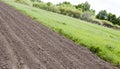 Brown ground plowed field, harrow lines. Arable background. A freshly ploughed field Royalty Free Stock Photo