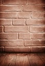 Brown grunge textured brick wall and wooden floor Royalty Free Stock Photo