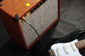 Brown guitar combo with black guitar on black background