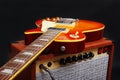 Brown guitar combo with honey sunburst guitar on  black background Royalty Free Stock Photo