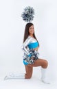 Brown-hair cheerleader with pom-poms.