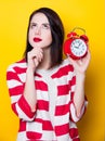 Brown hair girl with alarm clock Royalty Free Stock Photo