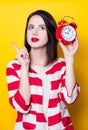 Brown hair girl with alarm clock Royalty Free Stock Photo