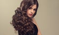 Brown haired woman with voluminous, shiny and curly hairstyle.Frizzy hair. Royalty Free Stock Photo