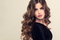 Brown haired woman with voluminous, shiny and curly hairstyle.Frizzy hair. Royalty Free Stock Photo
