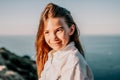 Adorable teenage girl outdoors enjoying sunset at beach on summer day. Close up portrait of smiling young romantic Royalty Free Stock Photo