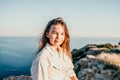 Adorable teenage girl outdoors enjoying sunset at beach on summer day. Close up portrait of smiling young romantic Royalty Free Stock Photo